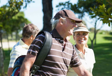 A couple walking together on a golf course