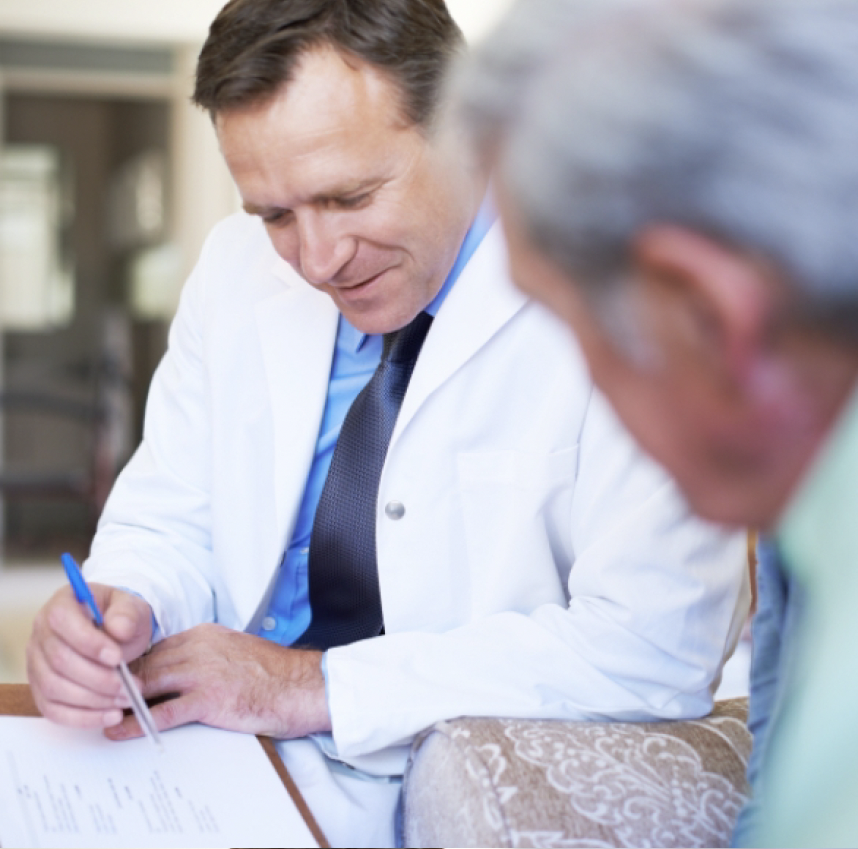 A doctor discussing items on a clipboard with a patient