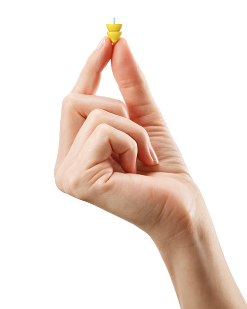 Audiologist holding up a Lyric Hearing Aid in Torrance, CA